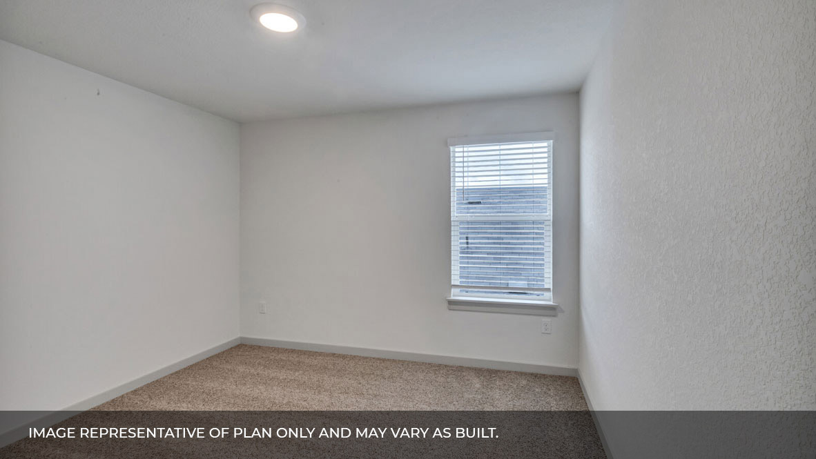 Bedroom with carpeted floors and large single window for natural light.