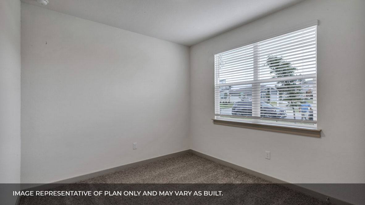 Bedroom with carpeted floors and large double window for natural light.