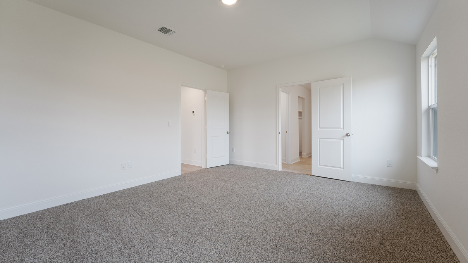 Bedroom 1 with carpeted flooring.