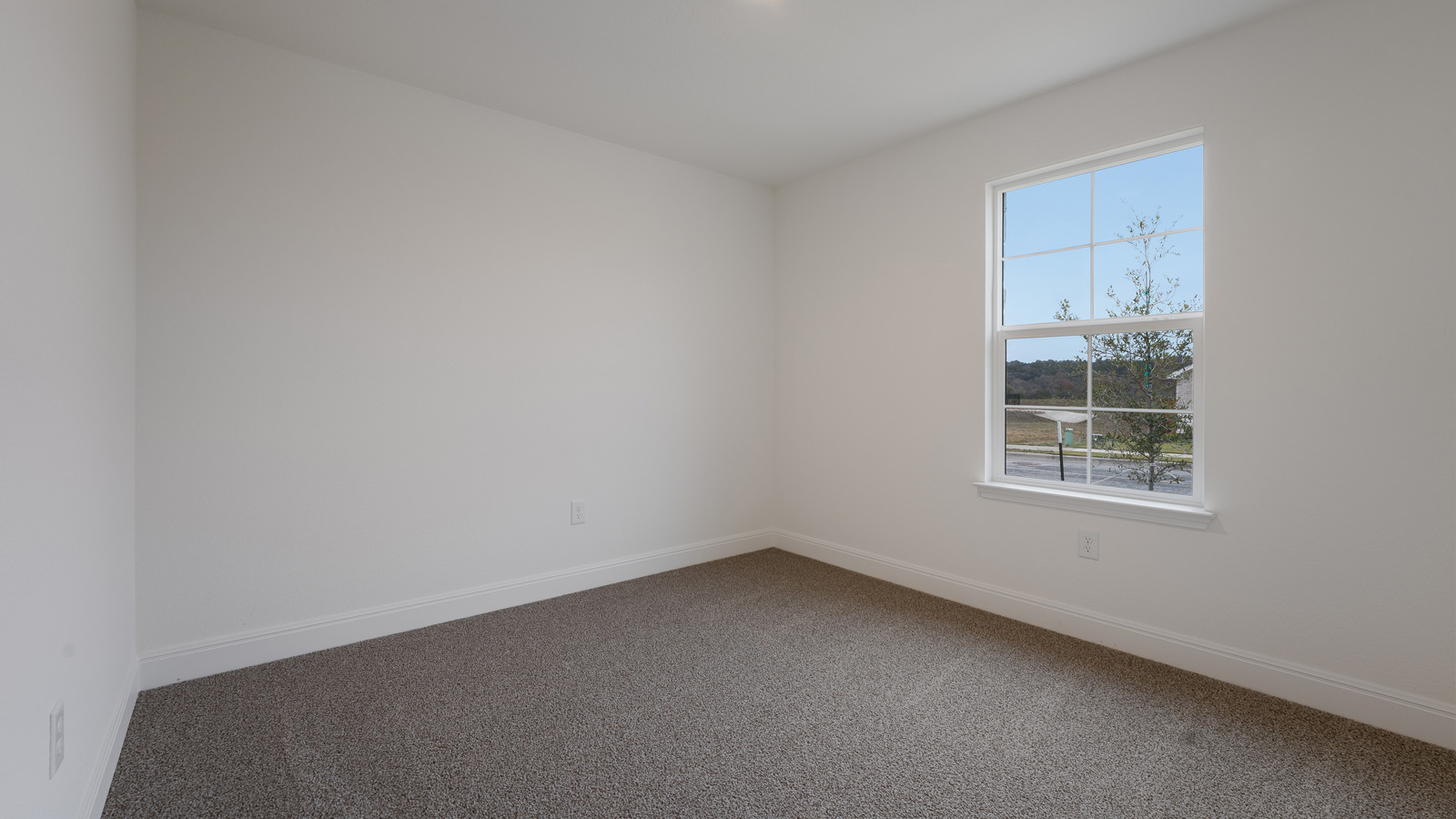 Bedroom 2 with carpeted floors and a storage closet.