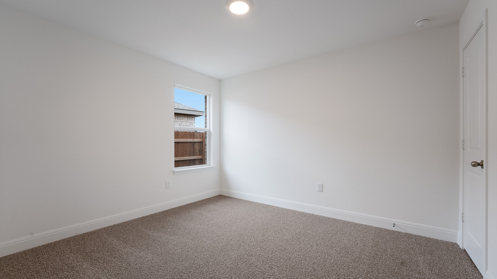 Bedroom 3 with carpeted floors and a storage closet.