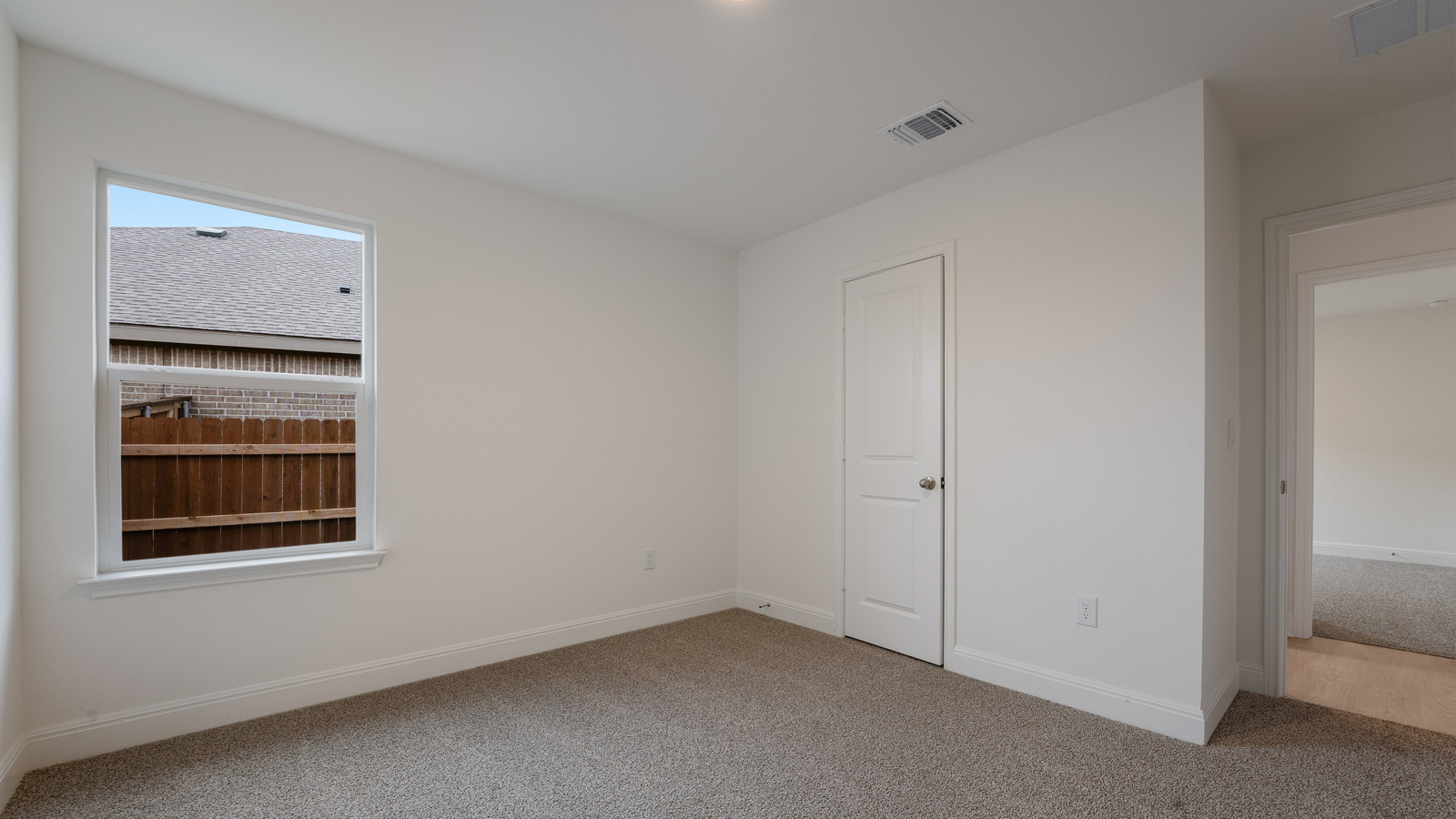 Bedroom 4 with carpeted floors and a storage closet.