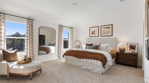The main bedroom, bedroom 1, with large windows and carpeted flooring.