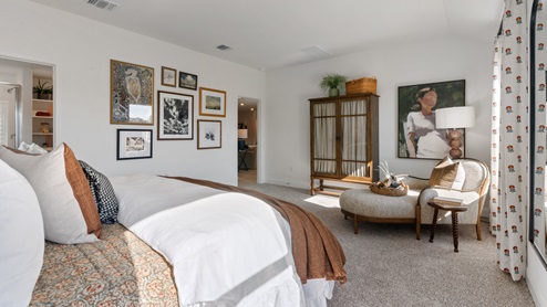 The main bedroom, bedroom 1, with large windows and carpeted flooring.