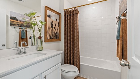 Bathroom 1 with bathtub and single vanity sink.