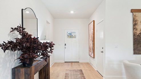 Model home entryway with laminated wood flooring