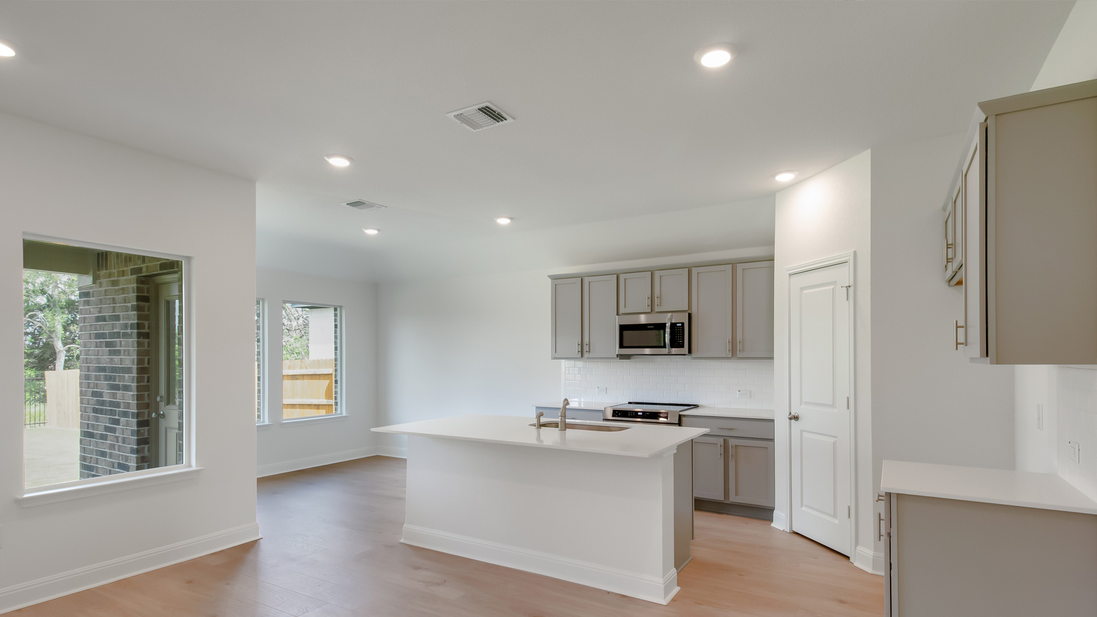Gourmet kitchen with stainless steel appliances and quartz countertops.