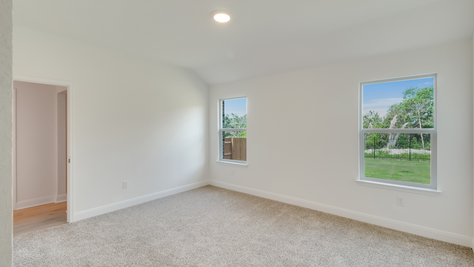 Bedroom 1 with carpeted flooring.