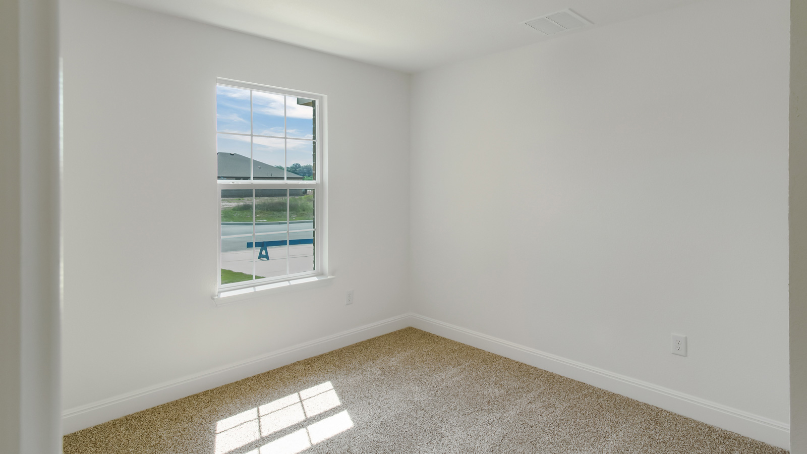 Bedroom 2 with carpeted floors and window.