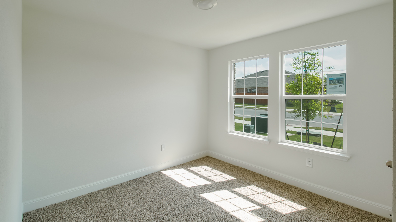 Bedroom 3 with two large winodws.