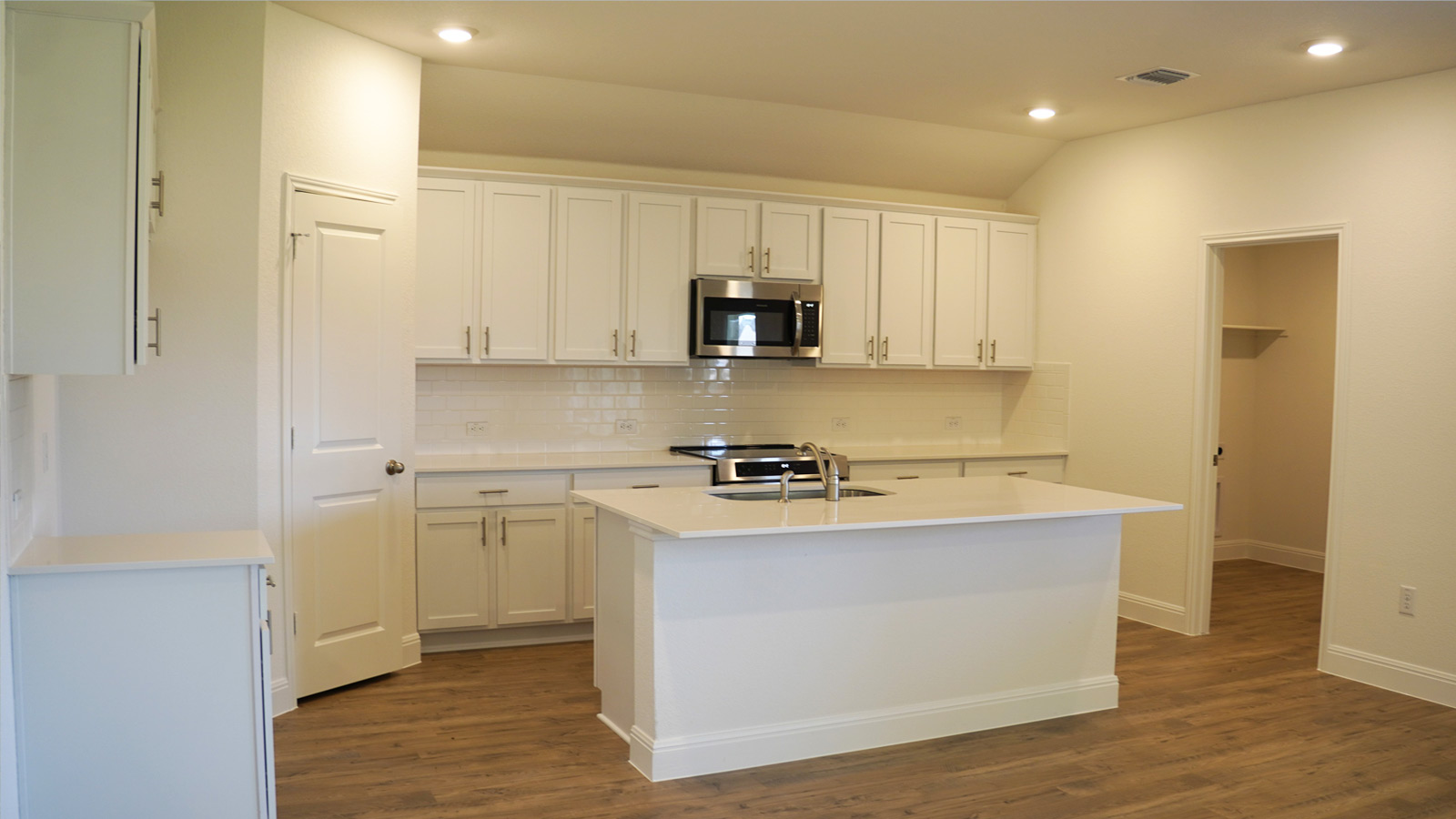 Open kitchen with stainless steel appliances.