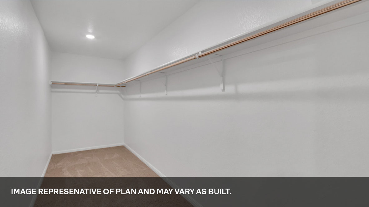 Primary suite walk-in closet in Durango new home with built-in shelving and generous storage