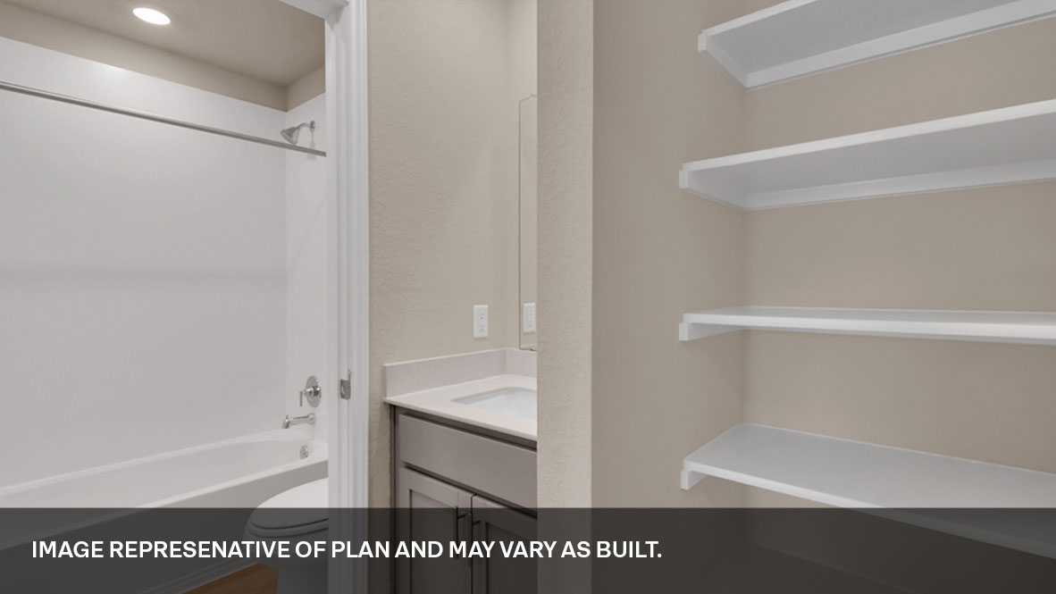 Family bathroom with stylish vanity, mirror, polished fixtures, cabinets, tub-shower combo in Durango