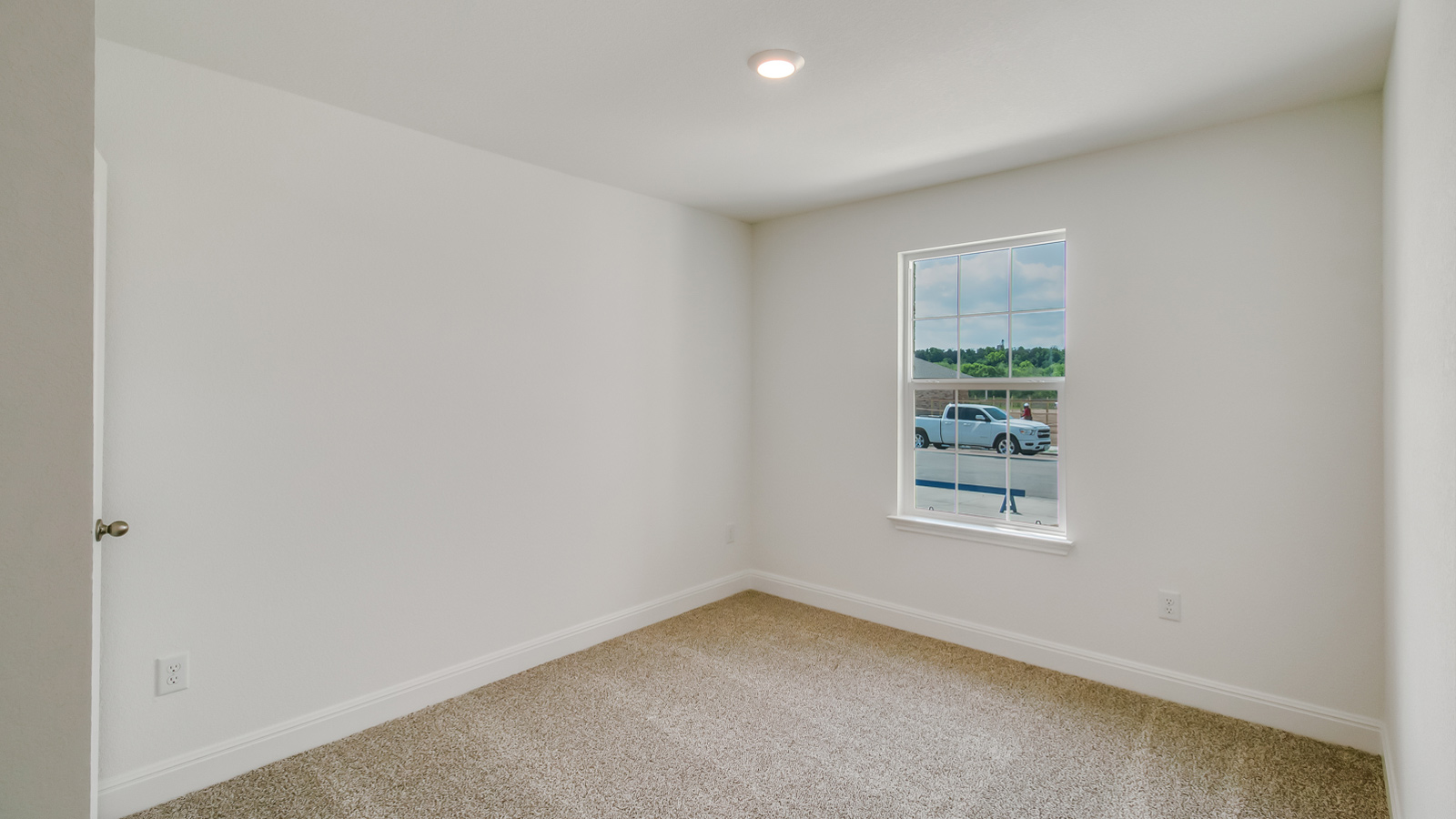 Bedroom 2 with carpeted floors and window.