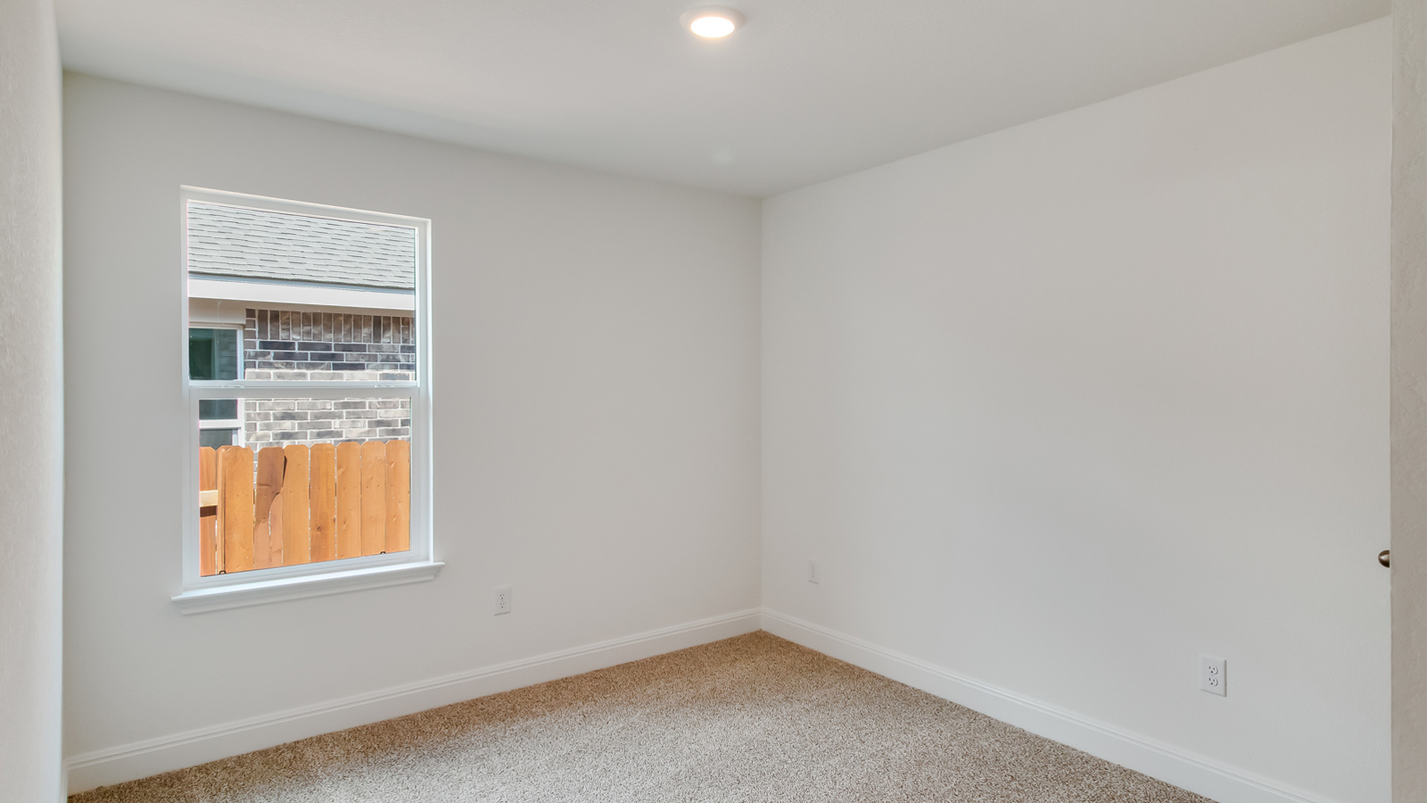 Bedroom 3 with carpeted floors and window.
