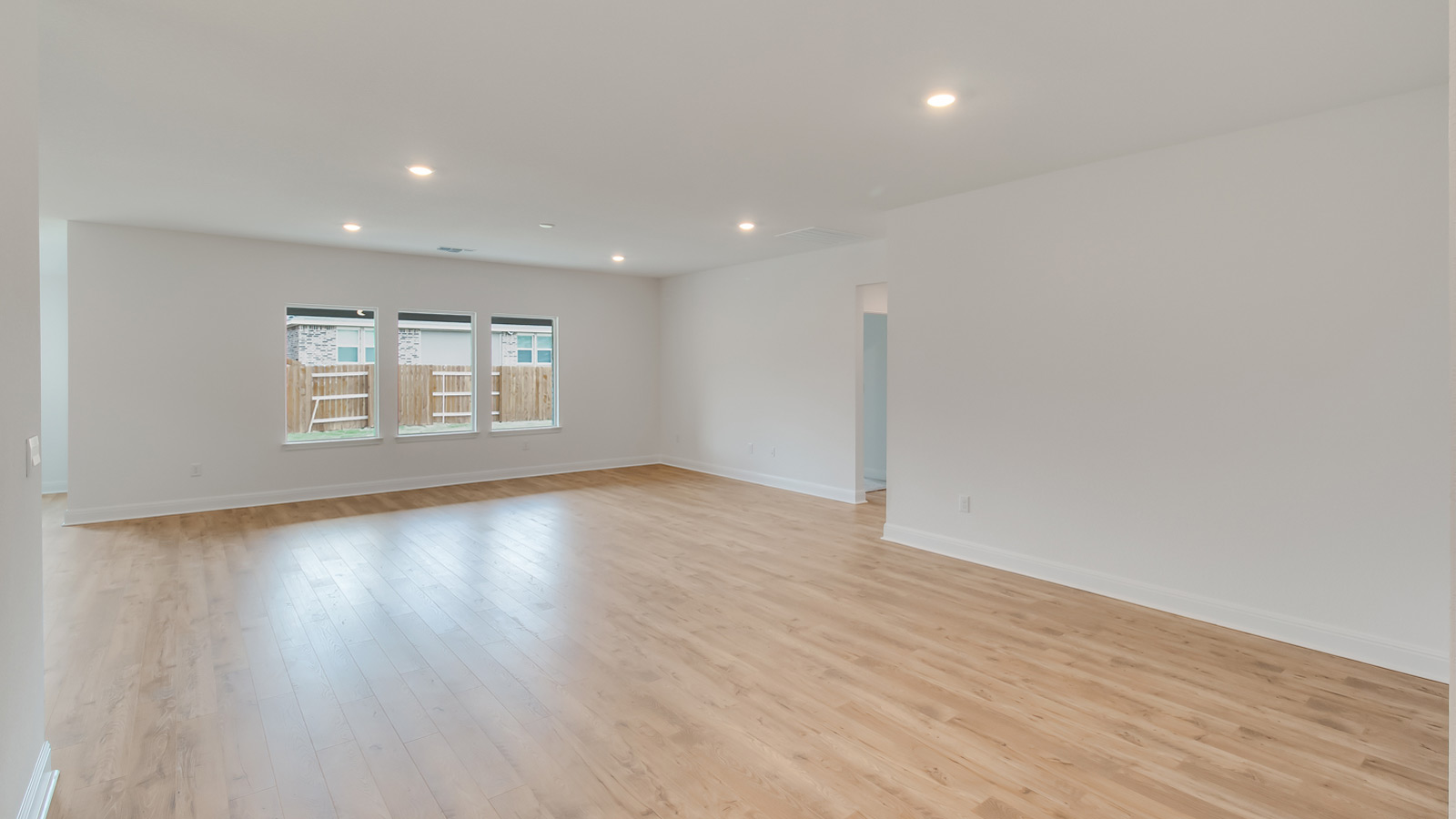 Open living area with laminated wood flooring.