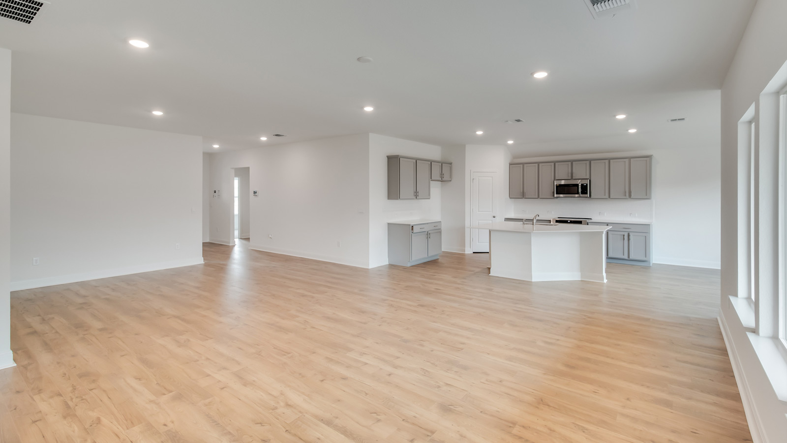 Open living area with laminated wood flooring.