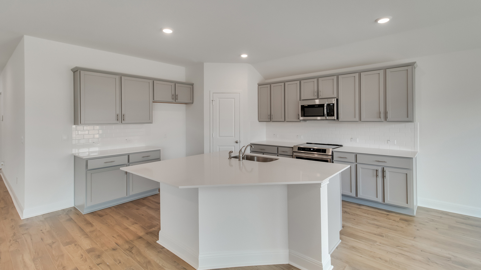 Gourmet kitchen with stainless steel appliances and quartz countertops.
