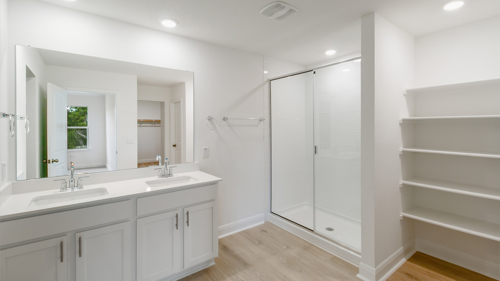 Bathroom 1 with double vanity sink, walk-in shower, and walk-in closet.