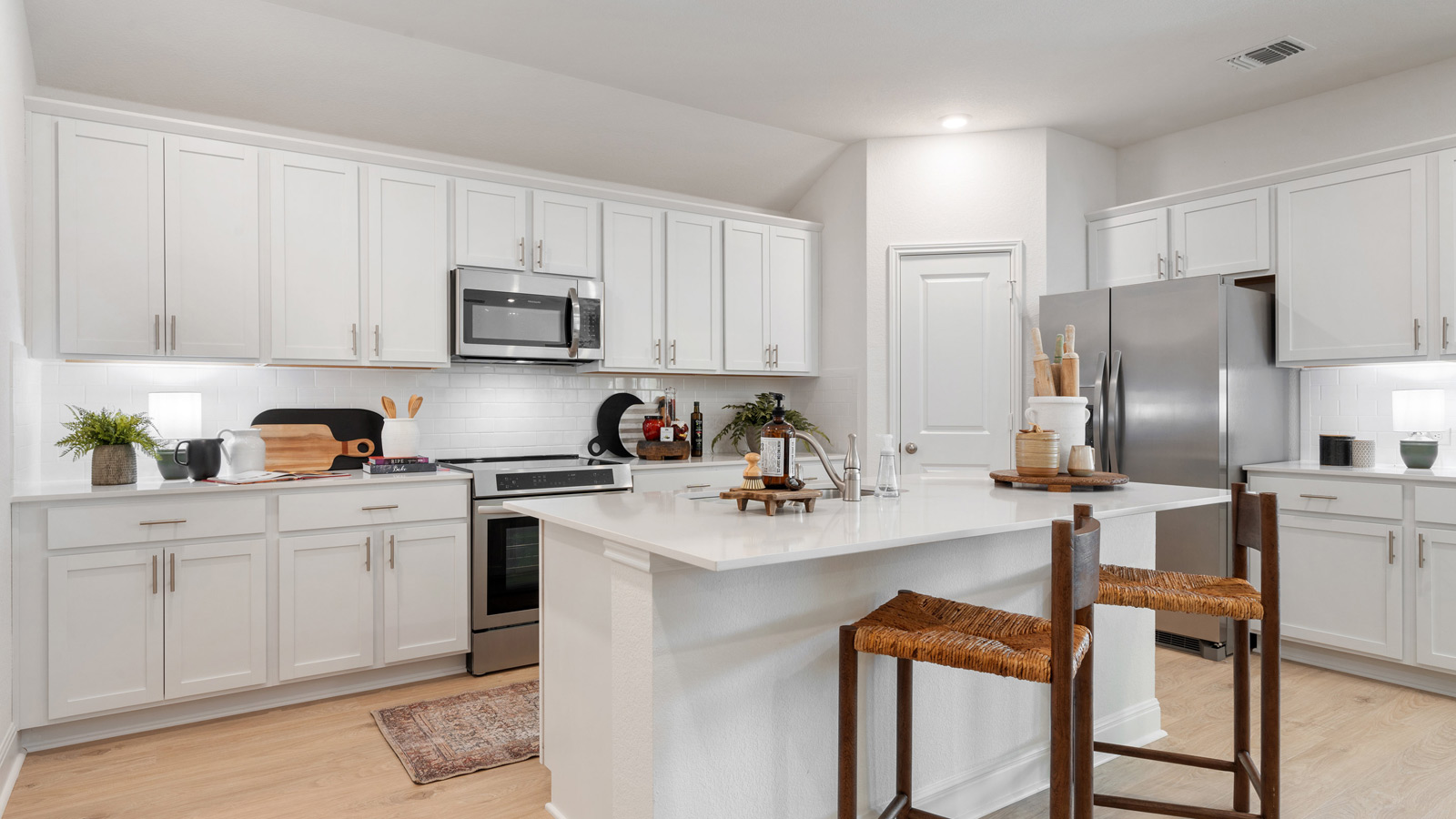 Gourmet kitchen with stainless steel appliances and quartz countertops.