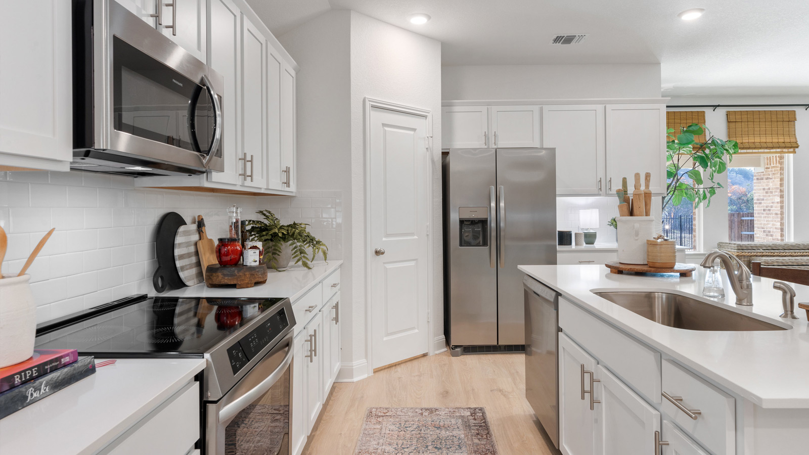 Gourmet kitchen with stainless steel appliances and quartz countertops.