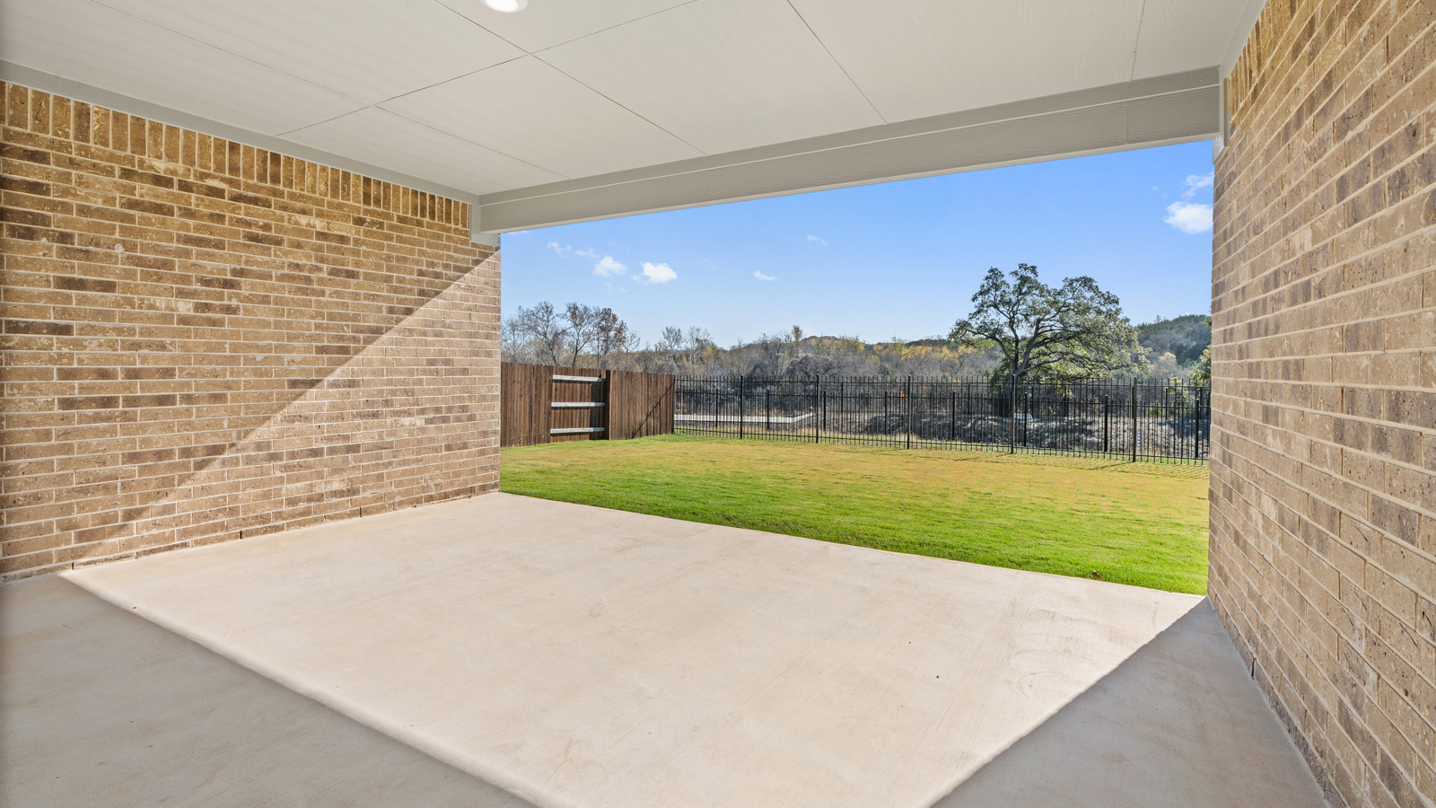 Backyard with large back patio.