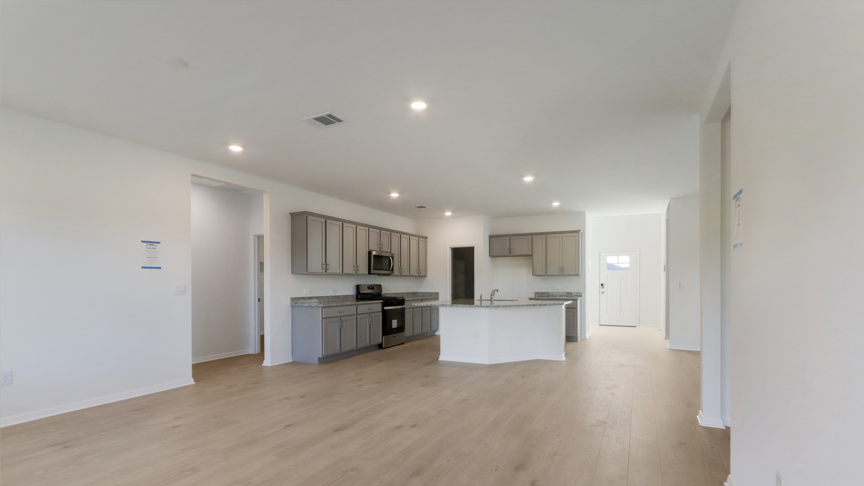 Living room with open view of kitchen.