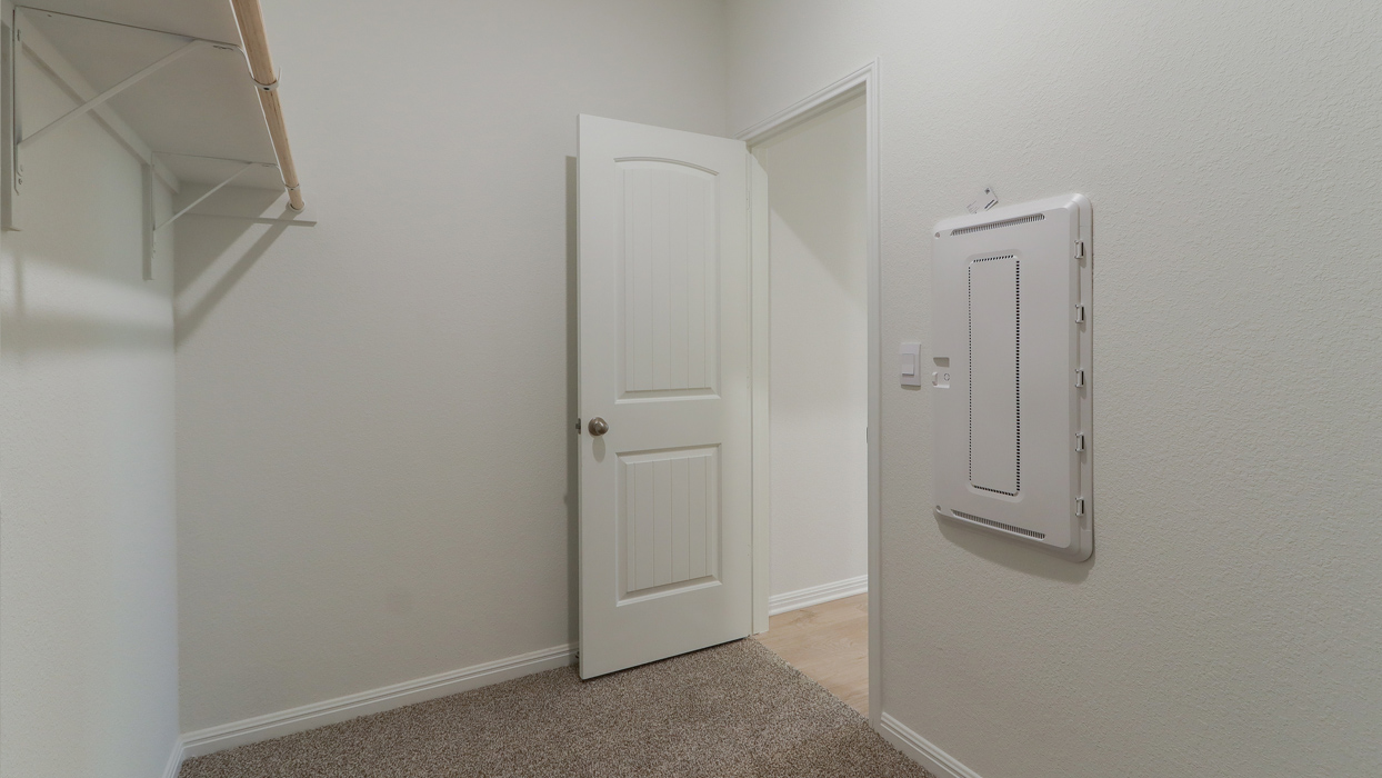 Large closet with carpeted floors.