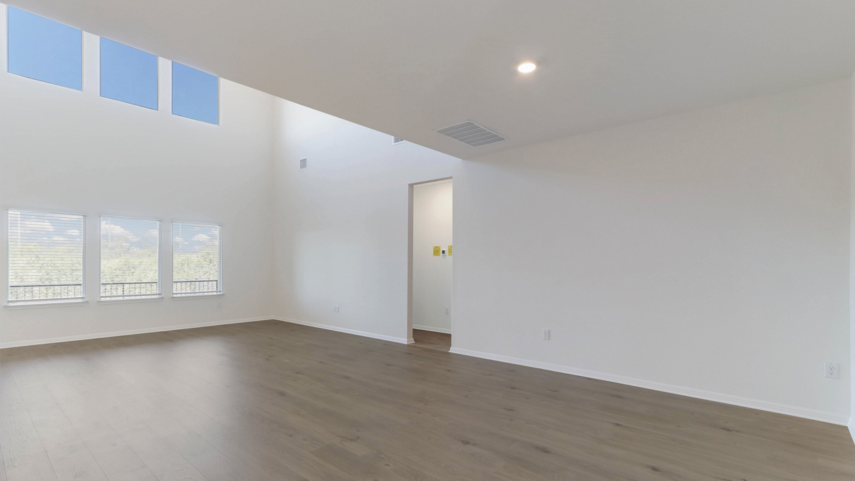 Living room with large windows for natural lighting.