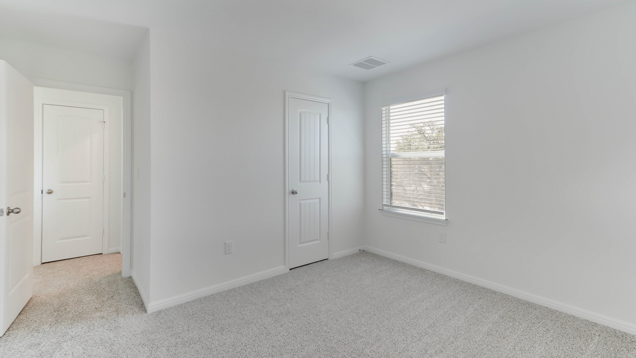 Bedroom with a closet and single window.