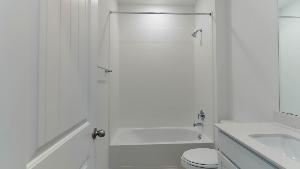 Bathroom with single vanity sink and a step in shower.
