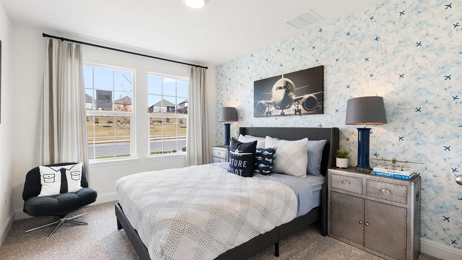 Secondary bedroom with window and carpet