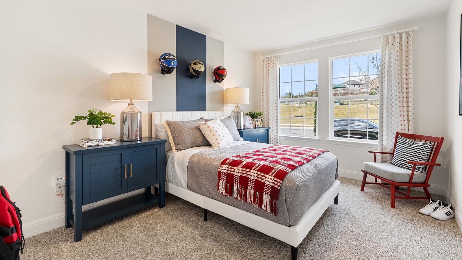 Secondary bedroom with window and carpet