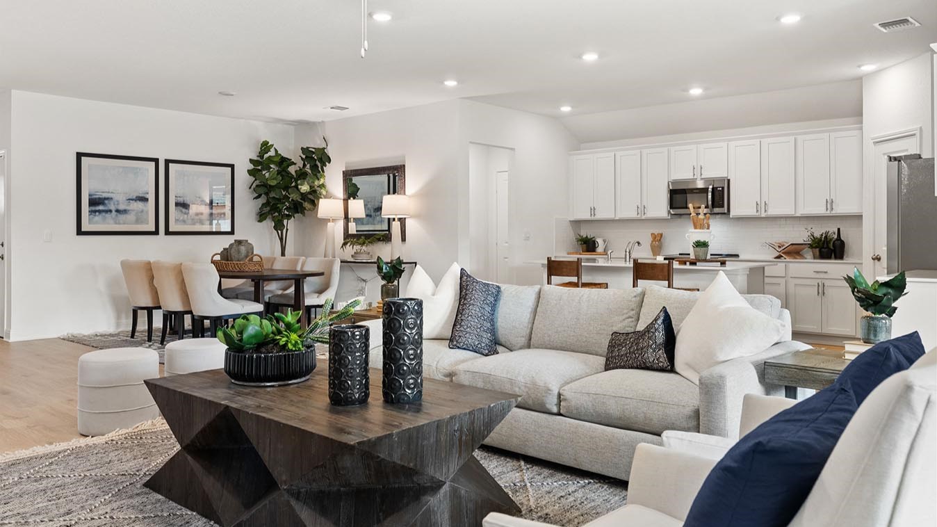 Living room with 3 large windows just off of the kitchen