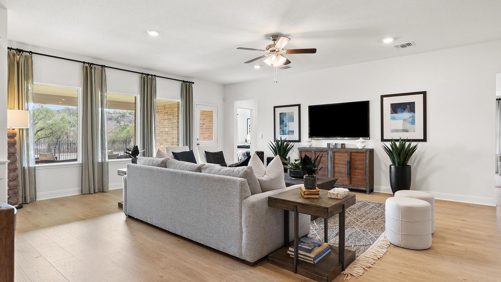 Living room with 3 large windows just off of the kitchen
