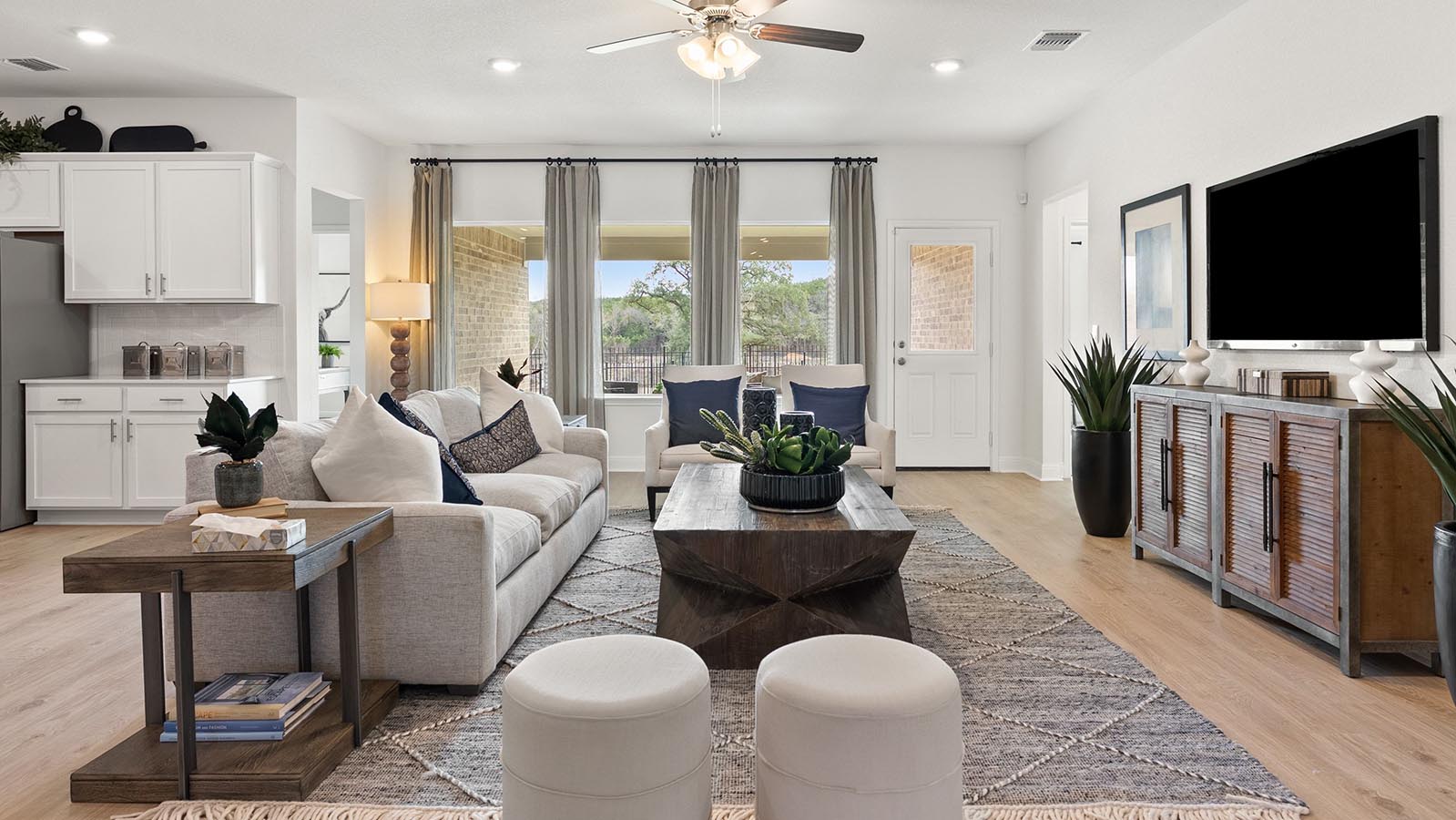 Living room with 3 large windows just off of the kitchen