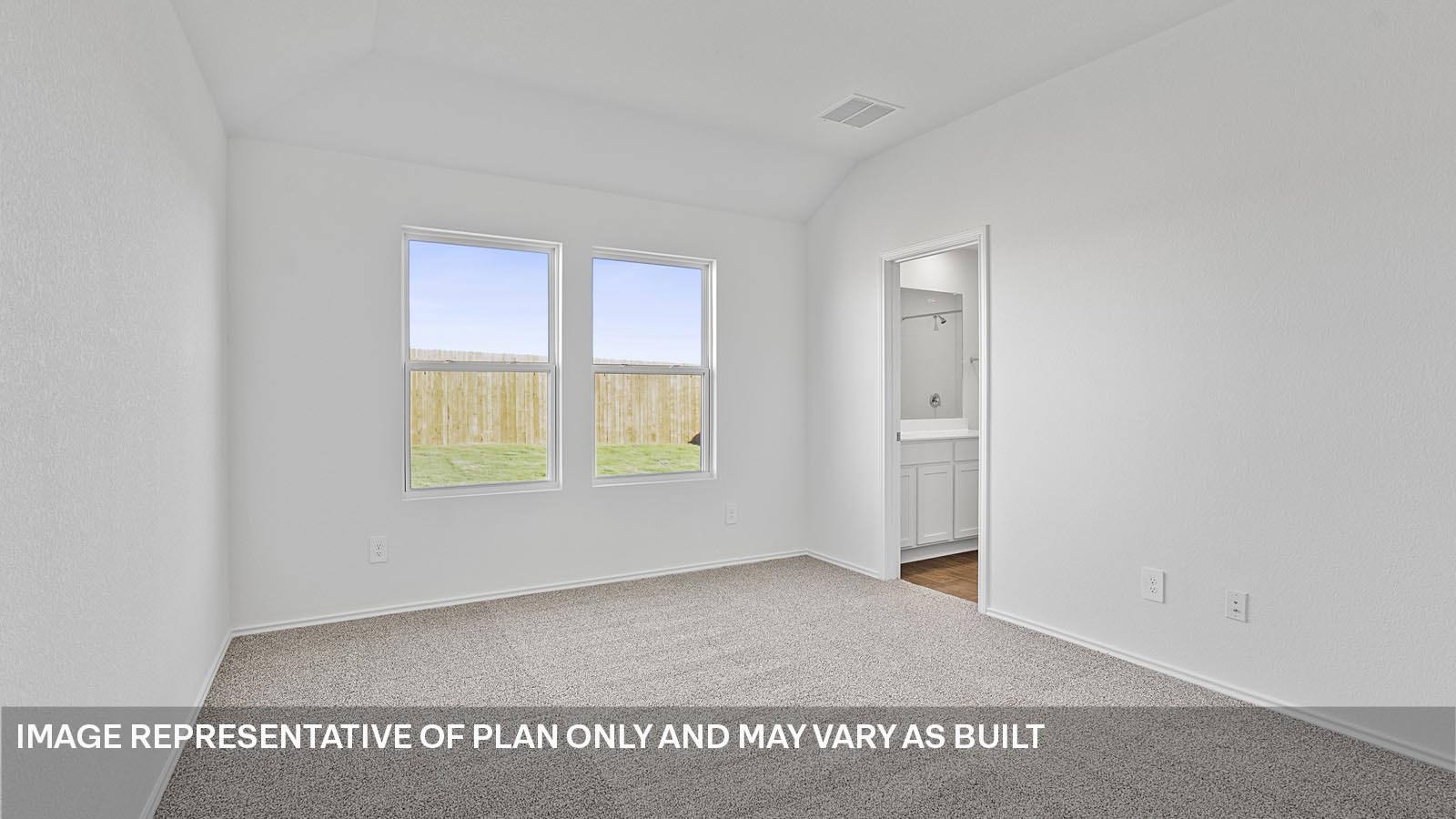 Primary bedroom with large windows.