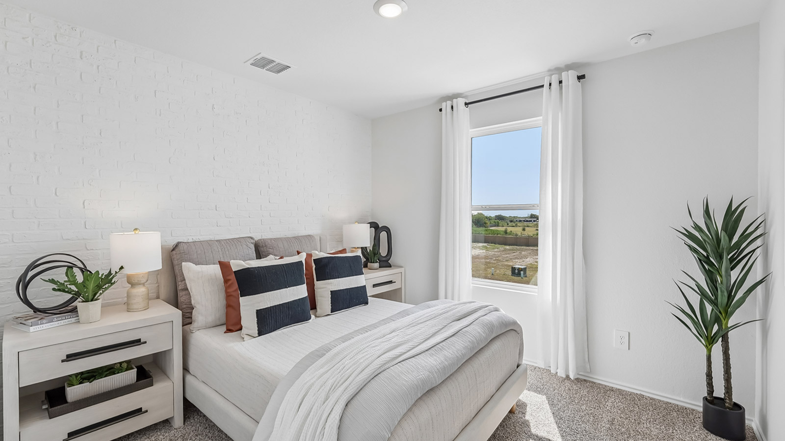 Bedroom 4 with window and carpeted flooring.