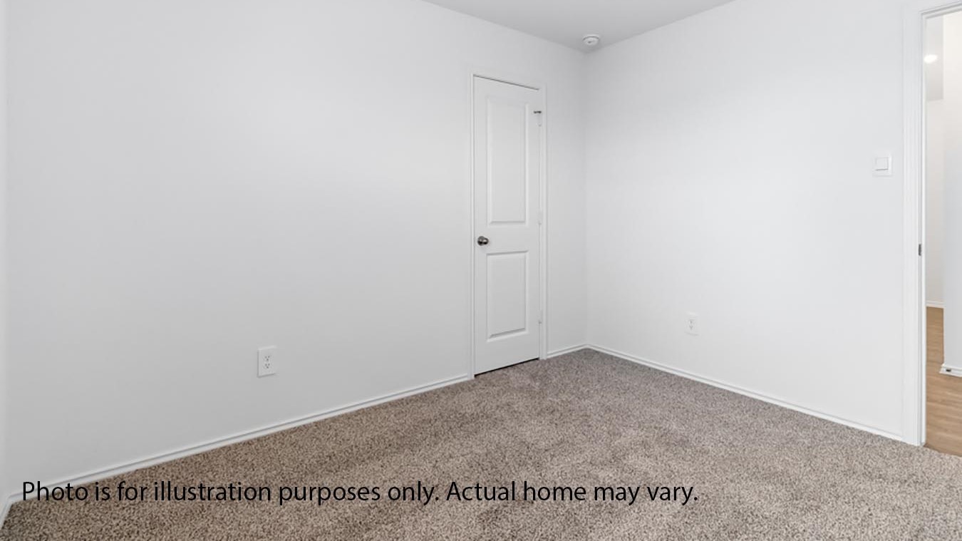 Secondary bedroom with carpet and window