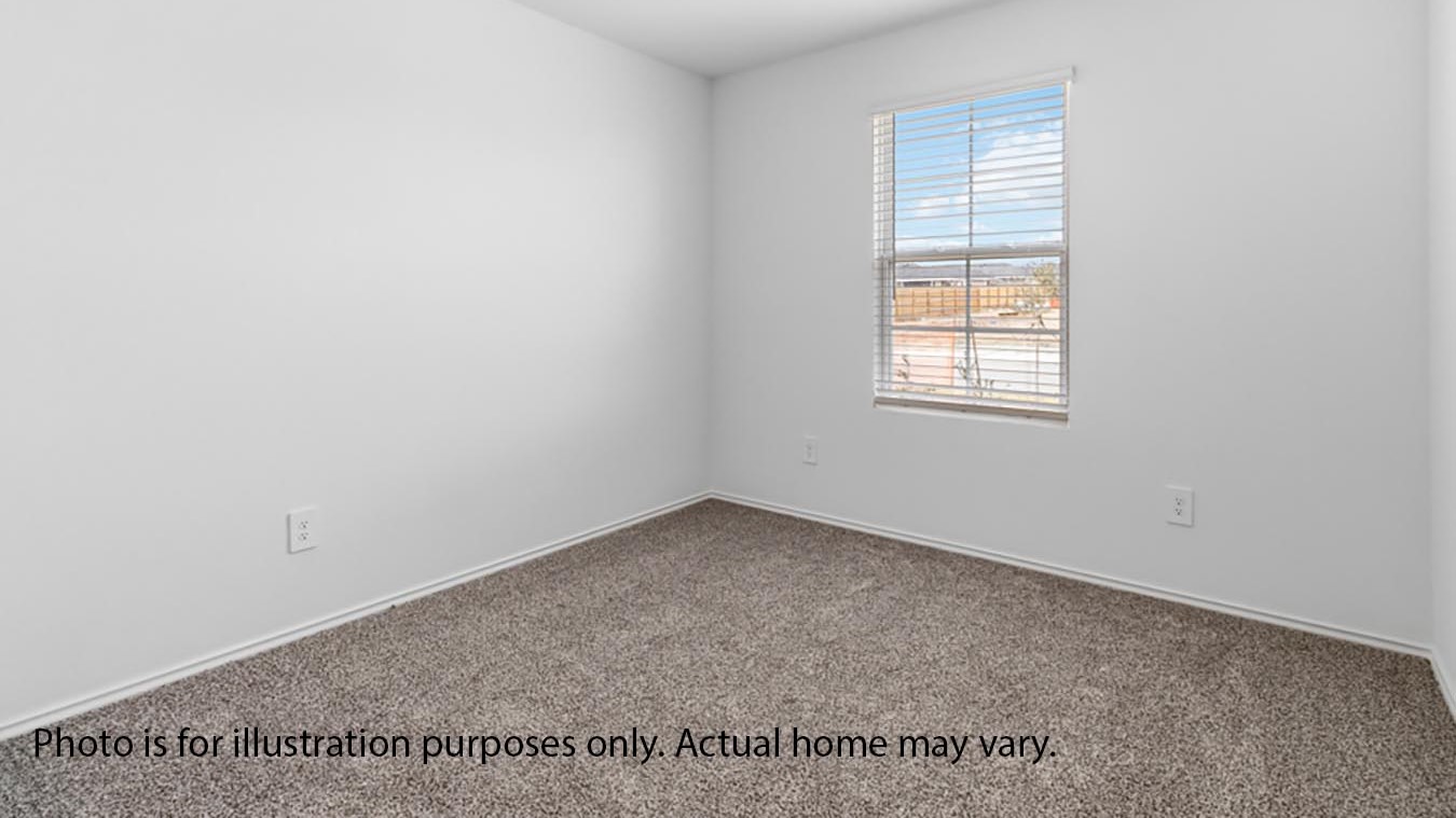 Secondary bedroom with carpet and window