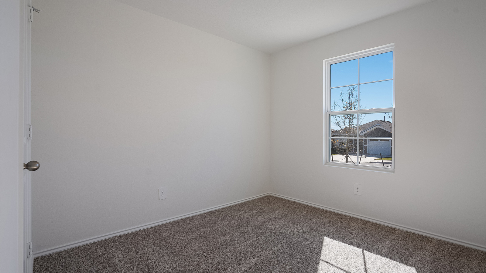 Bedroom 2 with carpeted floors.