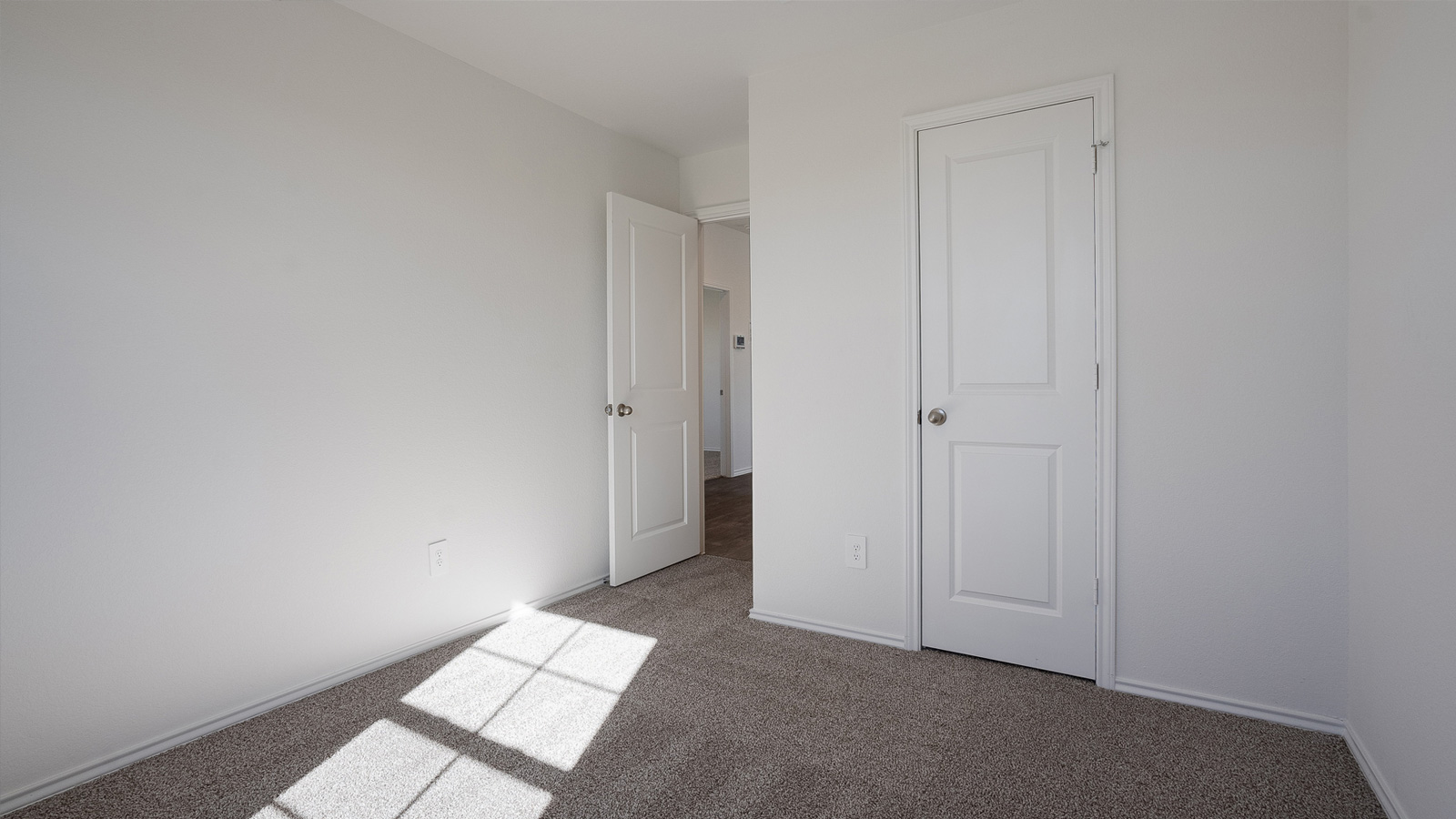 Bedroom 2 with carpeted floors.