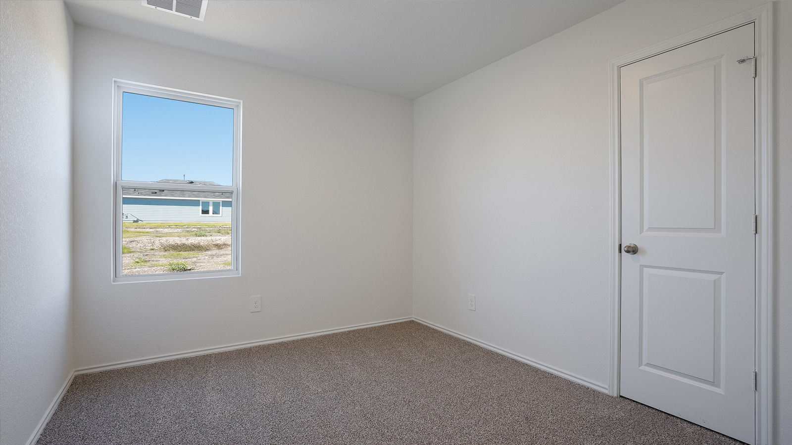 Bedroom 3 with carpeted floors.