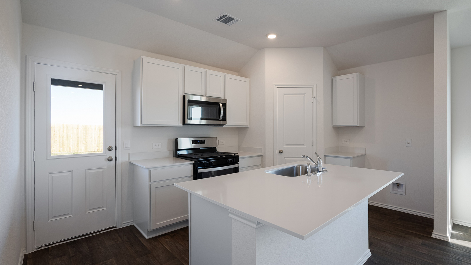Gourmet kitchen with quartz countertops and stainless steel appliances.