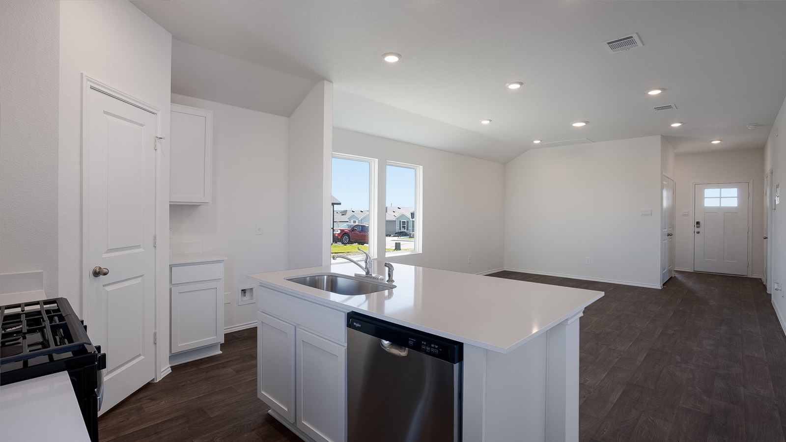 Gourmet kitchen with quartz countertops and stainless steel appliances.
