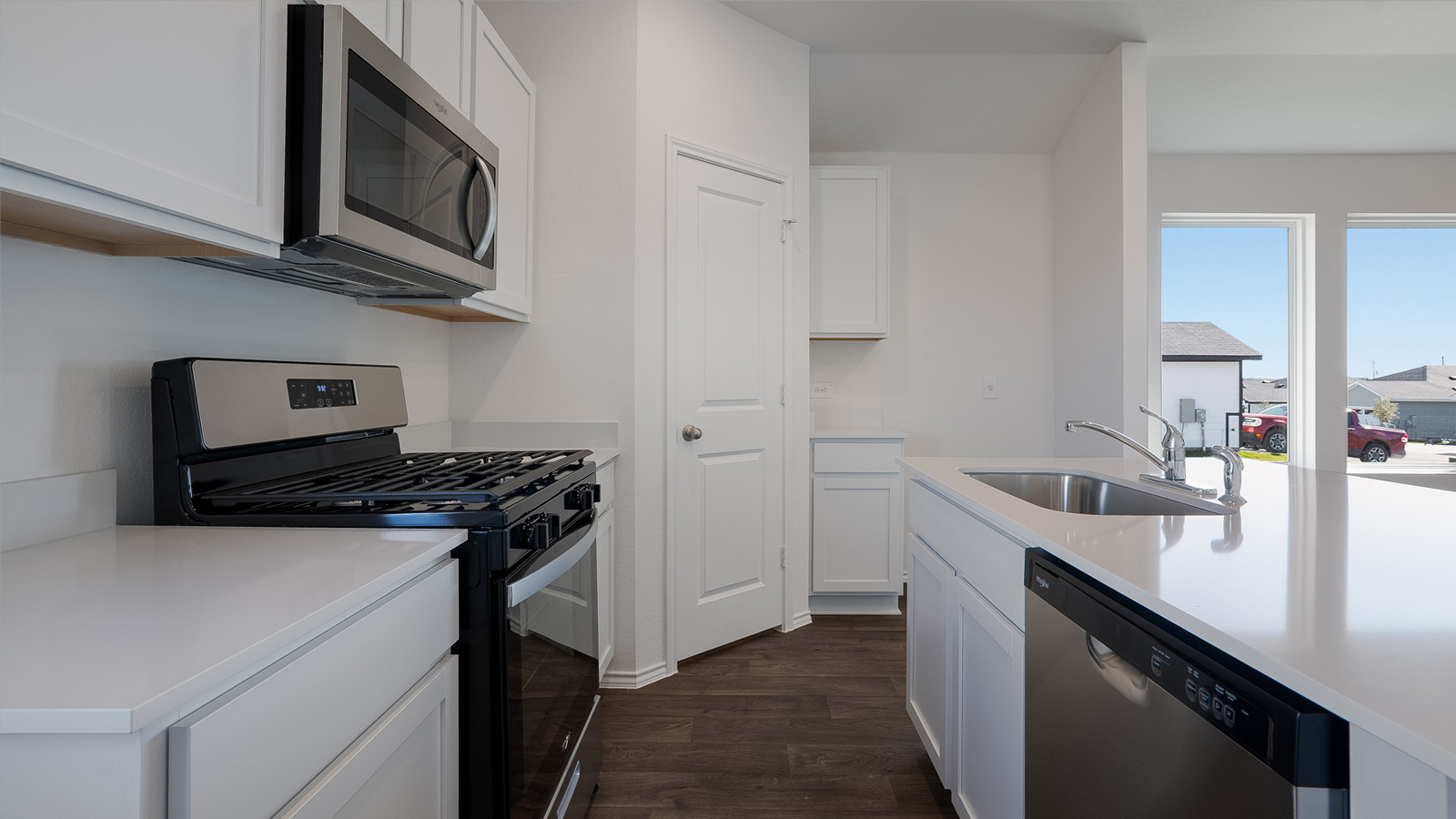 Gourmet kitchen with quartz countertops and stainless steel appliances.