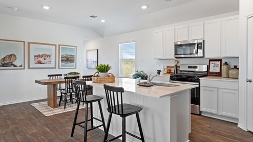 Kitchen with quartz countertops and stainless steel appliances.