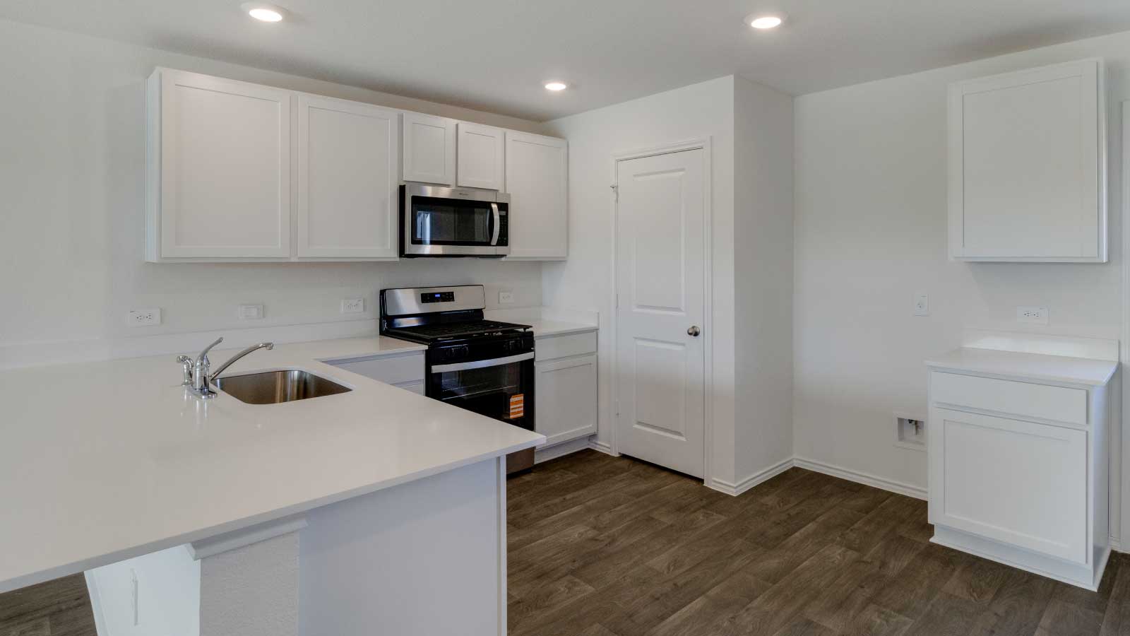 Kitchen featuring white cabinets, stainless steel appliances, and a large island.