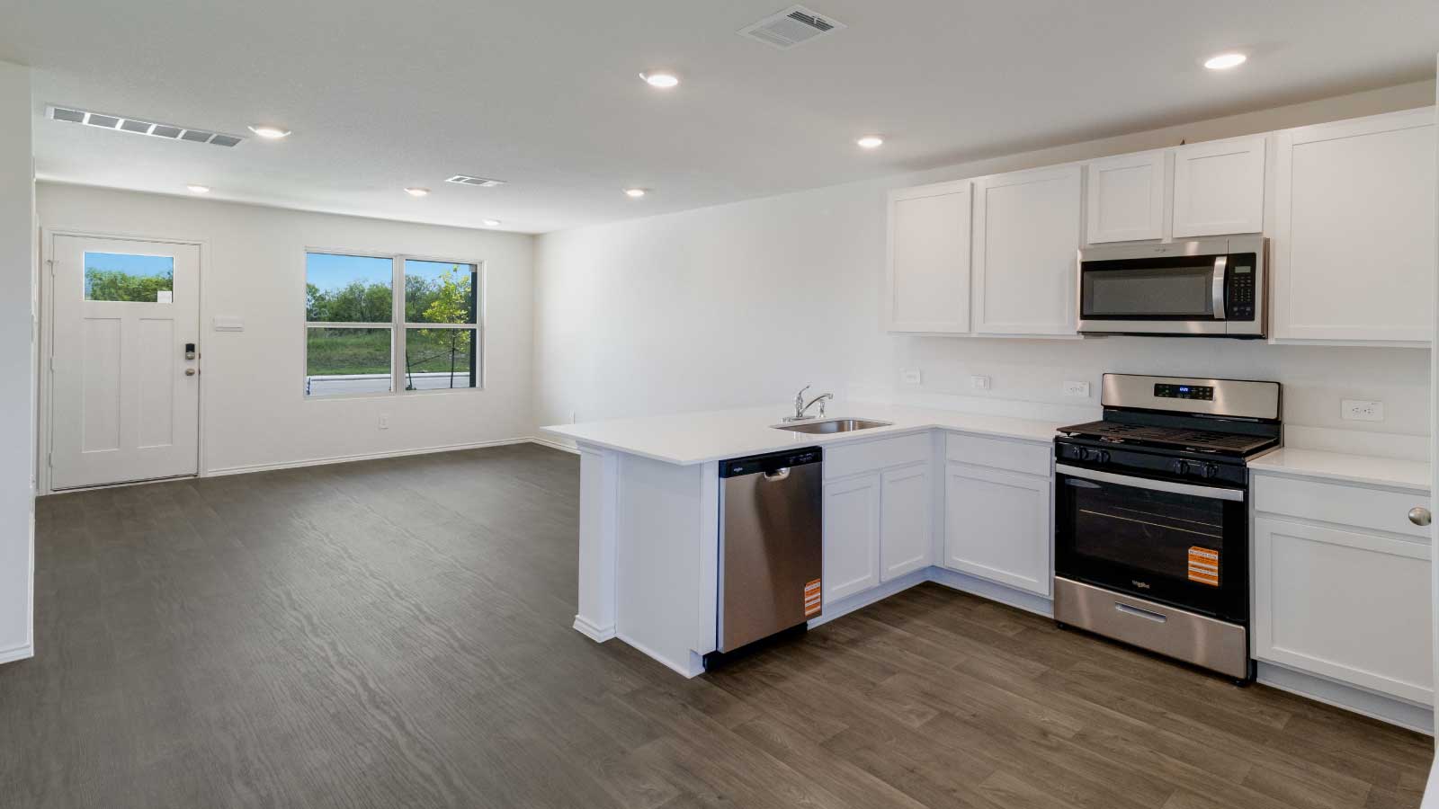 Kitchen featuring white cabinets, stainless steel appliances, and a large island.