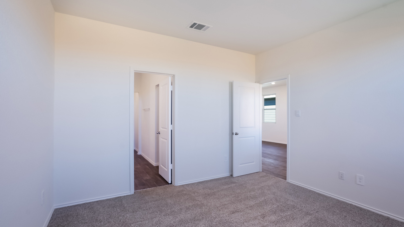 Spacious main bedroom, bedroom 1, with two large windows.